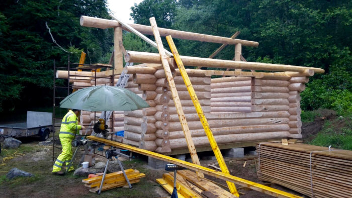 reassembling the Canadian log cabin fishing hut in situ