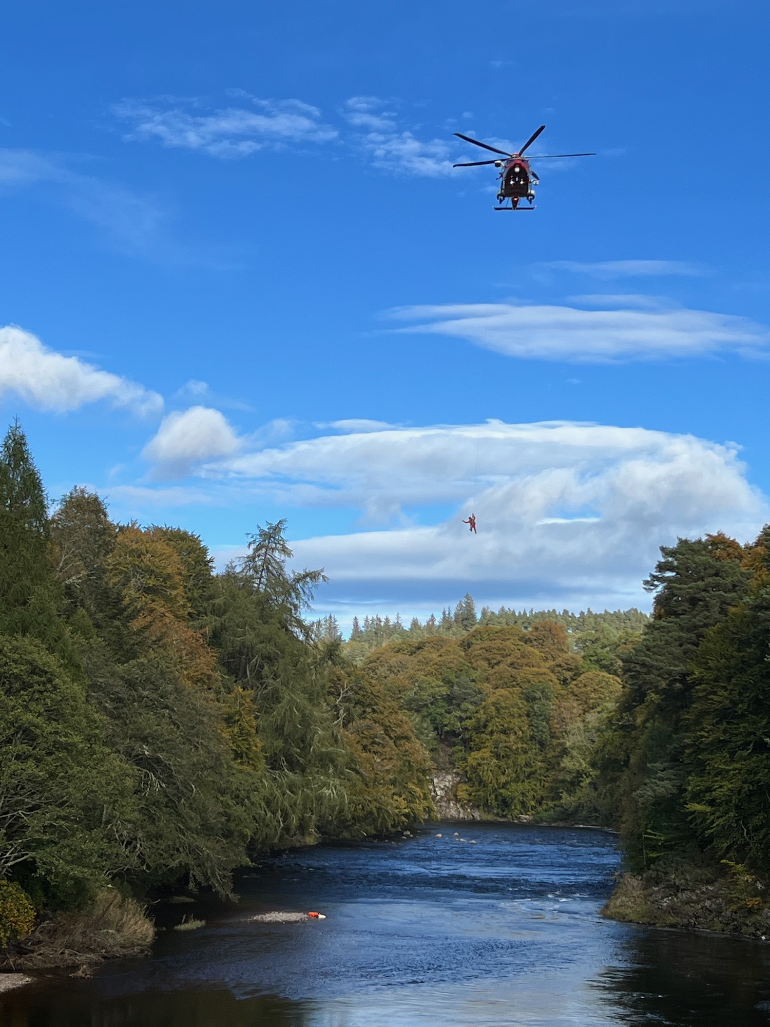 SFRS Exercise - helicopter over the river winching someone up